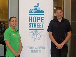 Two event attendees in front of Hope Street banner. 28 Nov 2013: Hope Street Annual General Meeting - click image to open event album